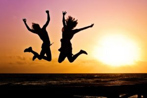 Two women jumping for joy